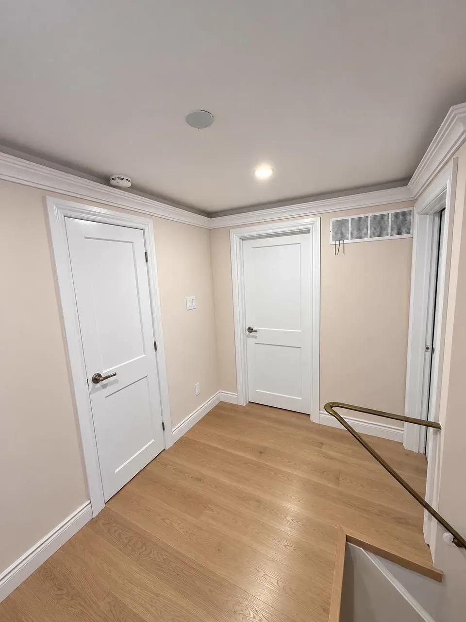 Finished hallway with crown moulding and hardwood flooring, renovated by SQFT