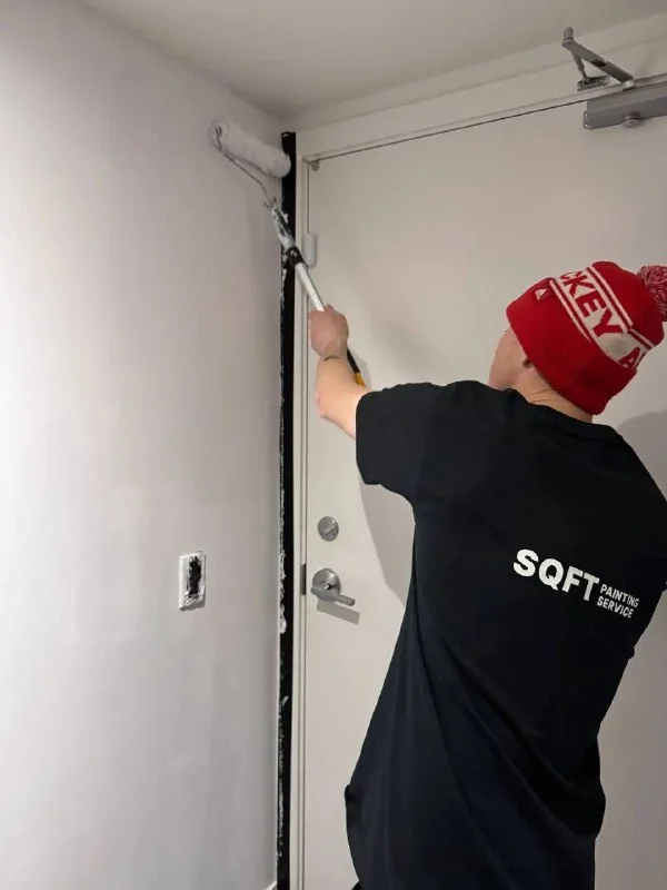 An SQFT Contracting painter at work in a Toronto home